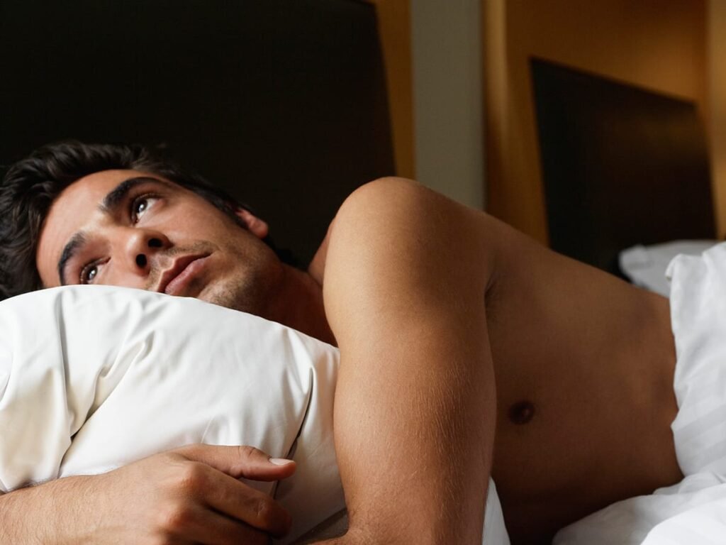 man awake in bed sleep main